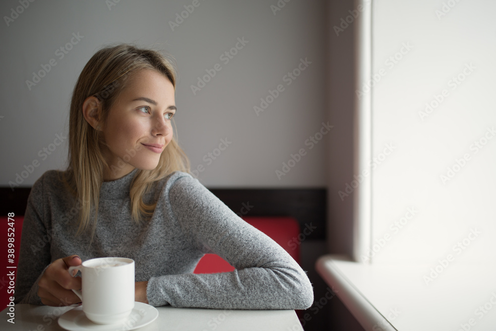 Joyful girl drinking coffee in a cafe Joyful girl drinking coffee in a cafe