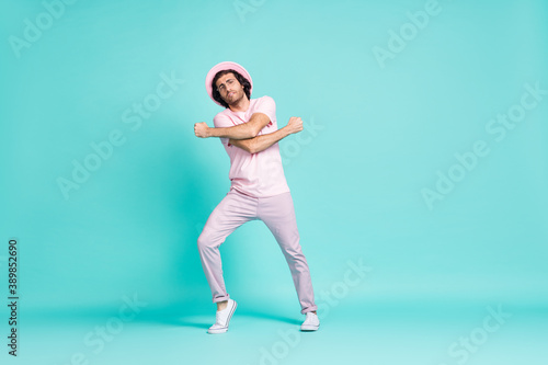 Fototapeta Naklejka Na Ścianę i Meble -  Full length photo of nice guy dancing wear cap spectacles t-shirt trousers sneakers isolated on teal color background