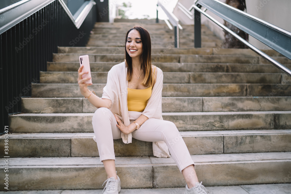 Cheerful lady taking selfie on smartphone Cheerful lady taking selfie on smartphone