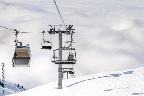 ski lift above the clouds mountain background