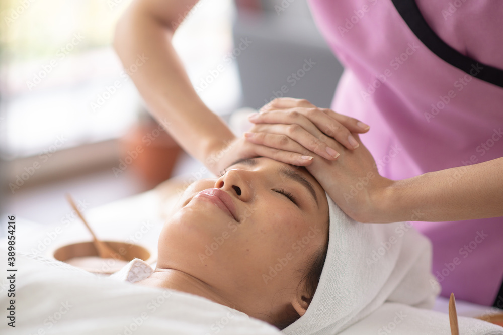 Therapist use her hand touch client forehead for treament Therapist use her hand touch client forehead for treament