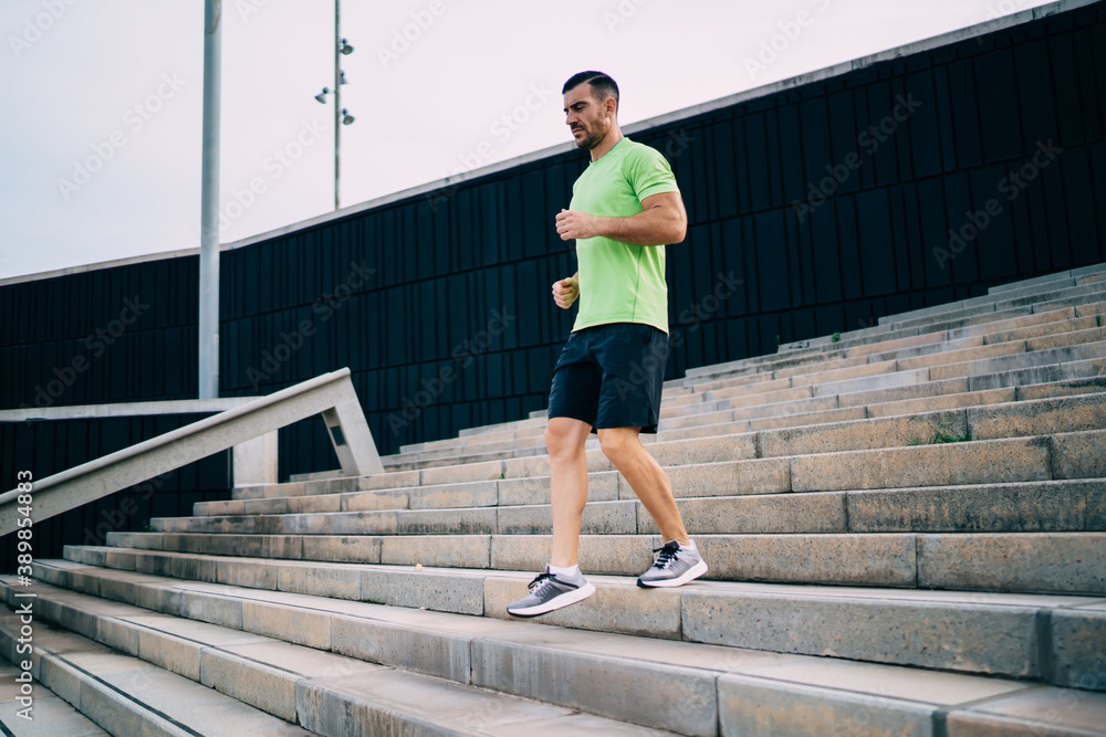 Sportsman doing cardio exercises on stairs Sportsman doing cardio exercises on stairs