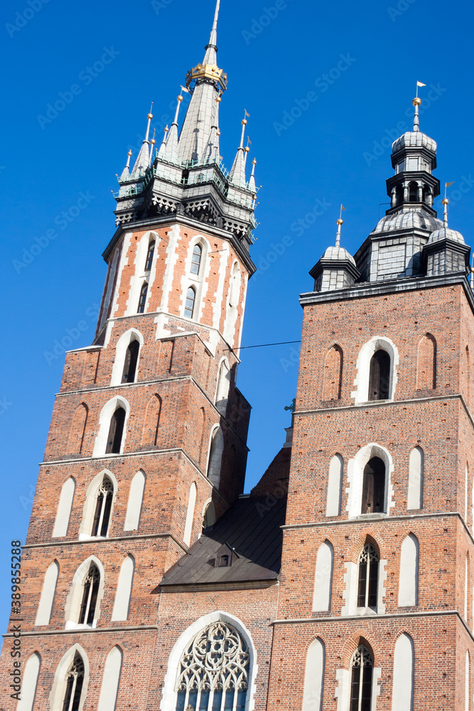 Krakow, Poland - February 17, 2019: Old city center view with Adam Mickiewicz monument and St. Mary's Basilica in Krakow