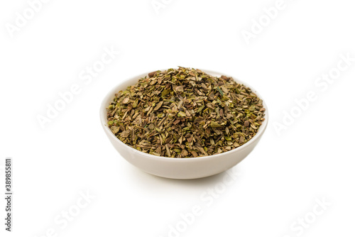 Oregano in a bowl isolated.