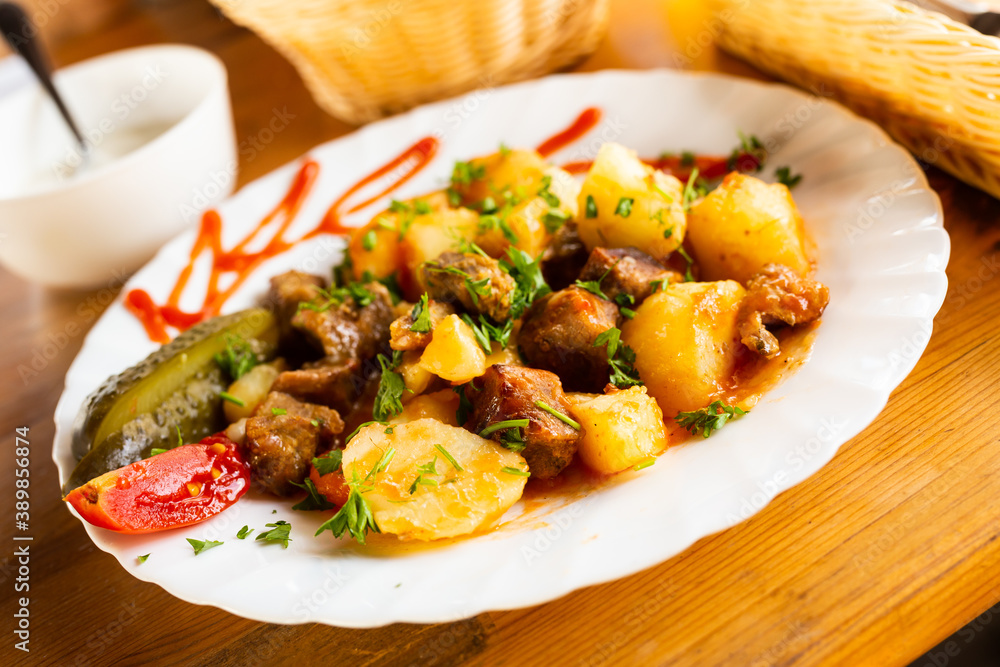 dish of baked potatoes with beef stew with herbs dish of baked potatoes with beef stew with herbs