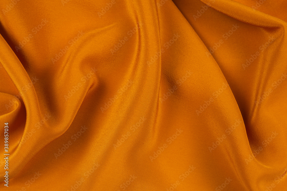 Fototapeta premium Golden silk or satin luxury fabric texture can use as abstract background.