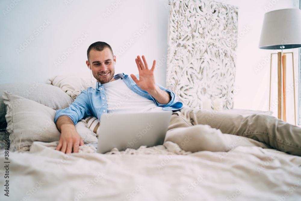 Excited man showing interesting gesture while talking on internet Excited man showing interesting gesture while talking on internet
