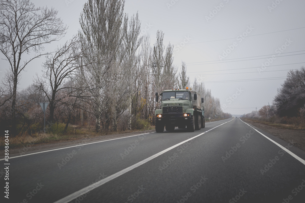 Truck on the road in the autumn Truck on the road in the autumn