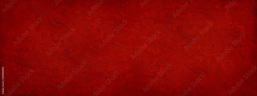 Abstract red background. Toned rough grainy texture. Decorative plaster on a concrete wall. Wide banner. Bright festive background for your design. Abstract red background. Toned rough grainy texture. Decorative plaster on a concrete wall. Wide banner. Bright festive background for your design.