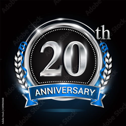 20th silver anniversary logo with blue ribbon and ring.