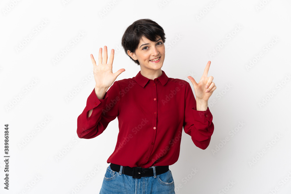 Woman with short hair isolated on white background counting seven with fingers Woman with short hair isolated on white background counting seven with fingers