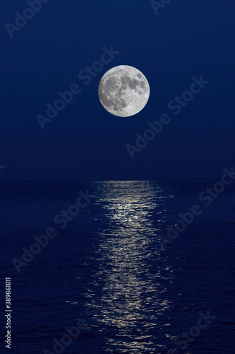Full moon reflection over the evening sea in Spanish Costa Brava