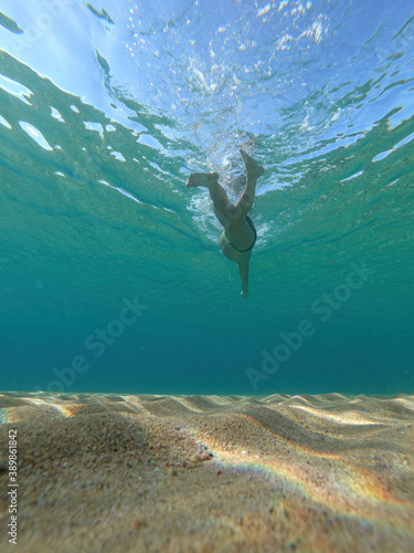 Sporty man swimming in a clear sea water in Spanish Costa Brava in summer
