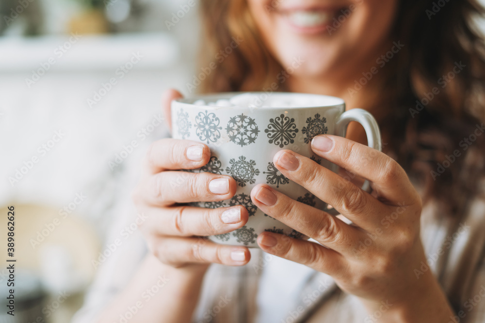 Attractive smiling woman with curly hair in plaid shirt with cup of cacao with marshmallow, cozy winter christmas mood Attractive smiling woman with curly hair in plaid shirt with cup of cacao with marshmallow, cozy winter christmas mood