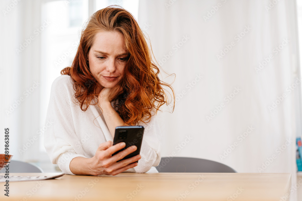 Troubled young woman reading on her mobile Troubled young woman reading on her mobile