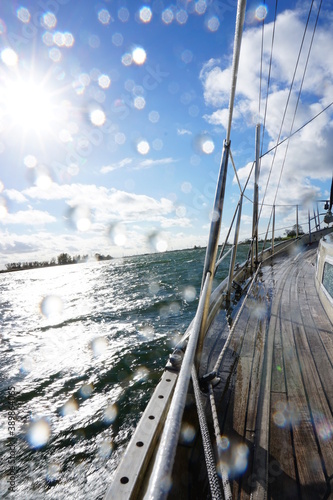 Rainy moment on the water, photo taken from an sail yach where blue sky shows.