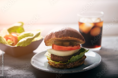 Vegan Burger. Plant-based fake meat substitute for real meat. Concept of veggie hamburger to reduce meat consumption globally