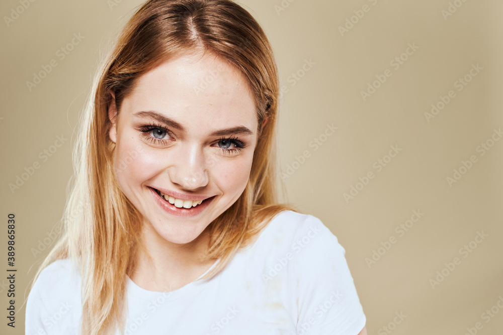 Cheerful blonde gesturing with her hands studio beige background Cheerful blonde gesturing with her hands studio beige background