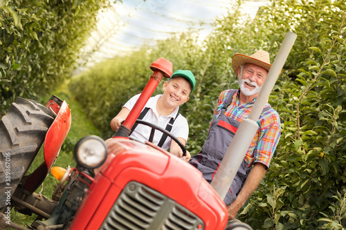 Happy grandfather and grandson on tractor © Cherries