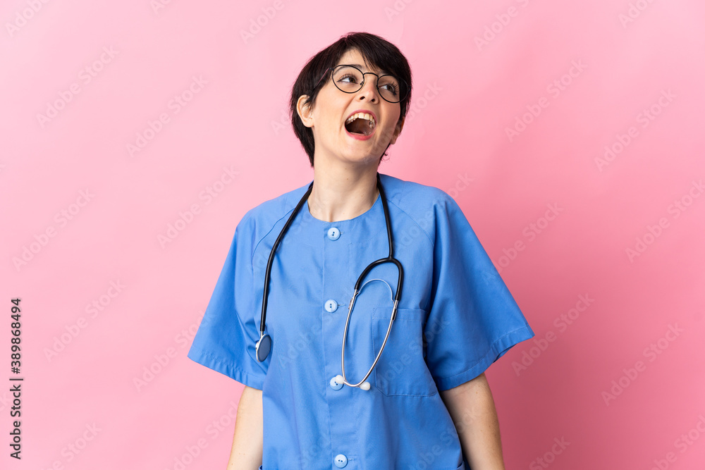 Surgeon isolated on pink background laughing Surgeon isolated on pink background laughing