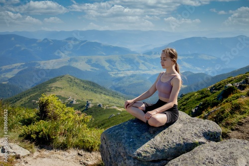 Yoga, Meditation. Woman balanced, practicing meditation and zen energy yoga in mountains. Woman doing fitness exercise sport outdoors in morning. Healthy lifestyle concept.