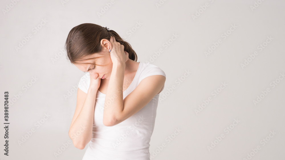 Tired woman feeling neck pain, massaging tense muscles Tired woman feeling neck pain, massaging tense muscles