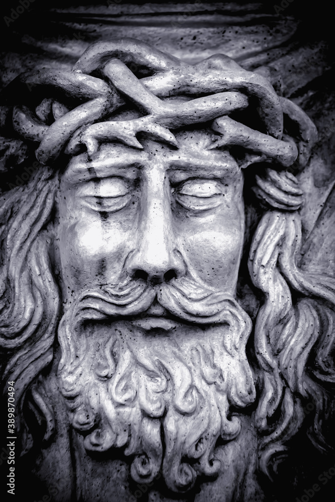 Very ancient statue of holy shroud with face of God Jesus Christus. Close up vertical image. This statue is in public domain and in Ukraine it is not subject to copyright law.