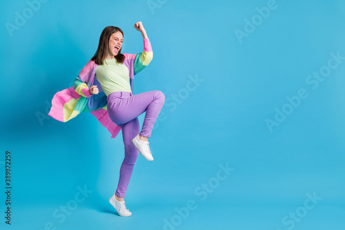 Fototapeta Naklejka Na Ścianę i Meble -  Full length photo of lucky funny lady wear casual colorful outfit dancing fists up open mouth isolated blue color background