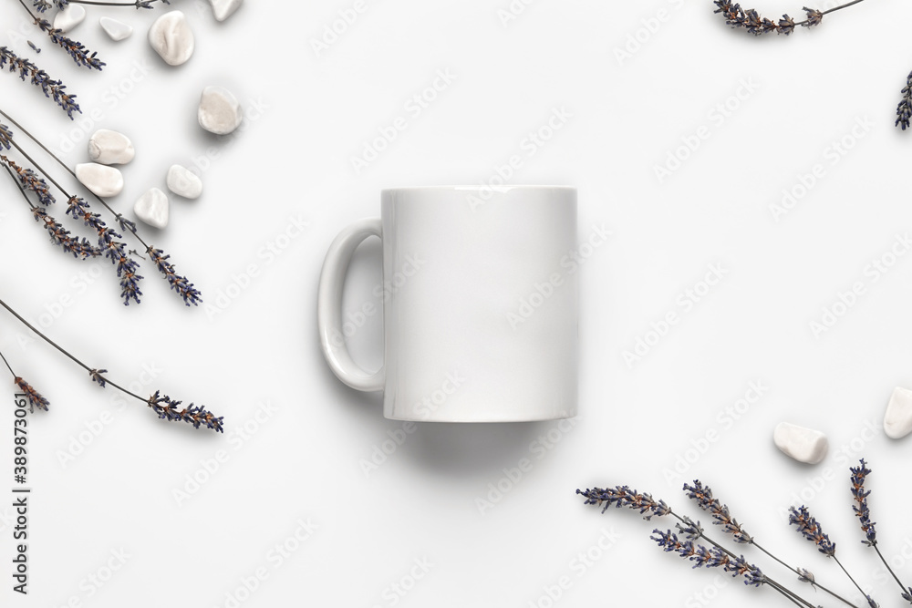 Cup with no logo, purple lavender flowers and small sea stones isolated on white background. Close up, copy space. Mock up, top view, flat lay Cup with no logo, purple lavender flowers and small sea stones isolated on white background. Close up, copy space. Mock up, top view, flat lay