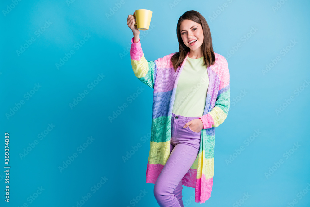 Photo of beautiful brown haired young woman raise cup drink latte good mood isolated on blue color background Photo of beautiful brown haired young woman raise cup drink latte good mood isolated on blue color background