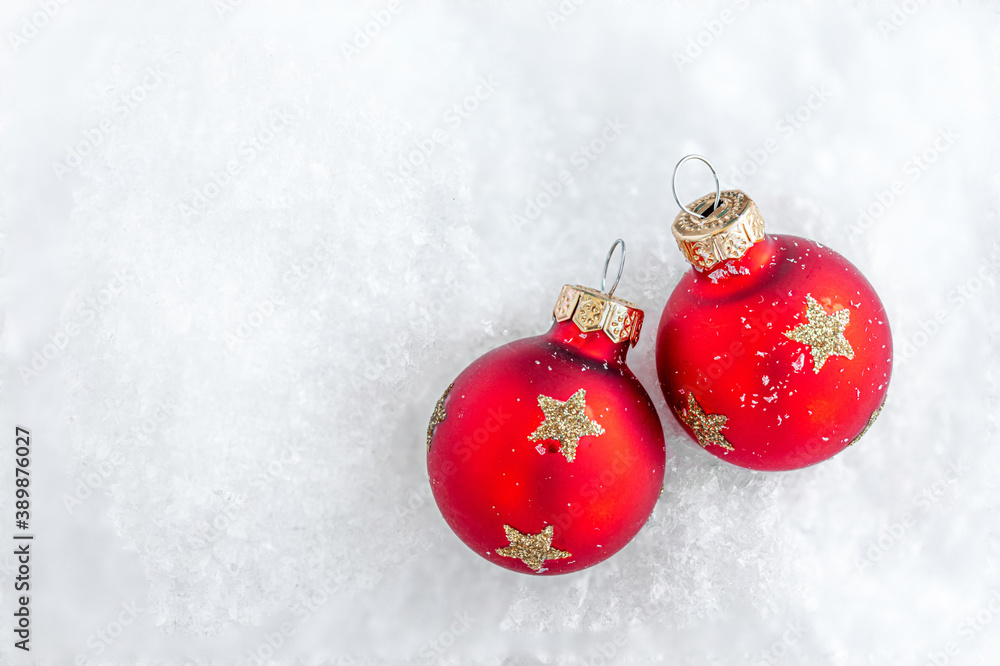 Christmas ornaments on snow with copy space. Glossy red balls top view. . Christmas ornaments on snow with copy space. Glossy red balls top view. .