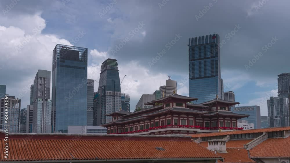 SINGAPORE - FEBRUARY 3: Time lapse video 4K, Buddha Tooth Relic Temple in Chinatown in Singapore, with Singapore business district in the background on February 3, 2020 in Singapore. SINGAPORE - FEBRUARY 3: Time lapse video 4K, Buddha Tooth Relic Temple in Chinatown in Singapore, with Singapore business district in the background on February 3, 2020 in Singapore.