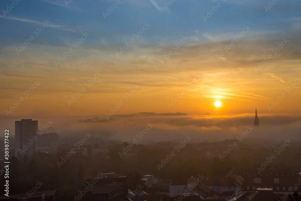 Cityscape of Graz with Church of the Sacred Heart of Jesus and historic buildings, in Graz, Styria region, Austria, at sunrise. Beautiful foggy morning over the city of Graz, in autumn