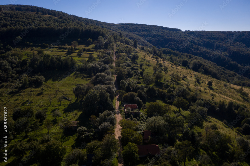 Aerial drone photograph with Lindenfeld deserted village in Semenic Mountains, Romania. The last inhabitant of the village, Paul Schwirzenbeck, died in 1998.