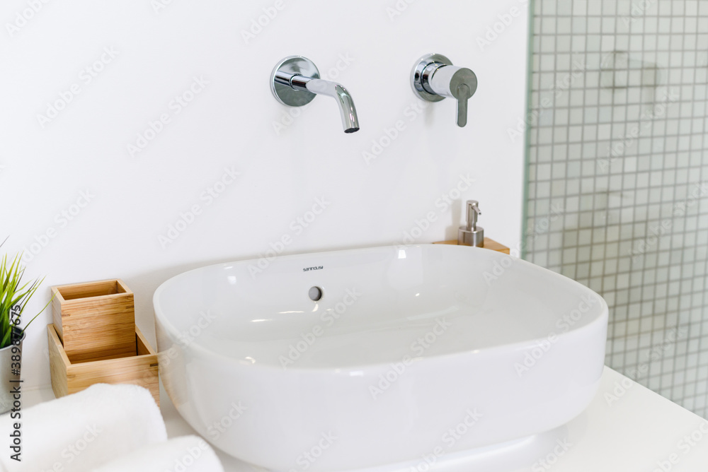 Fototapeta premium Ceramic Water tap sink with faucet with soap and towel in expensive loft bathroom or kitchen