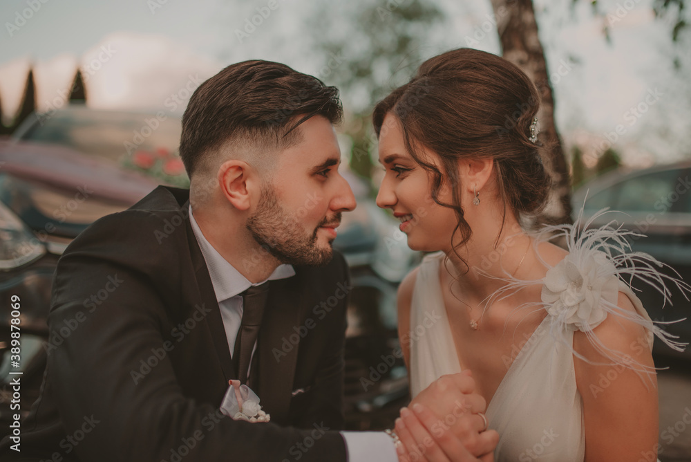 Bride and groom in a park kissing.couple newlyweds bride and groom at a wedding in nature green forest are kissing photo portrait.Wedding Couple Bride and groom in a park kissing.couple newlyweds bride and groom at a wedding in nature green forest are kissing photo portrait.Wedding Couple