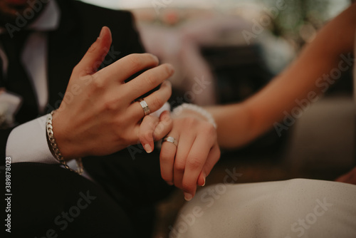 Groom Put on Wedding Ring Bride Hand © Minet