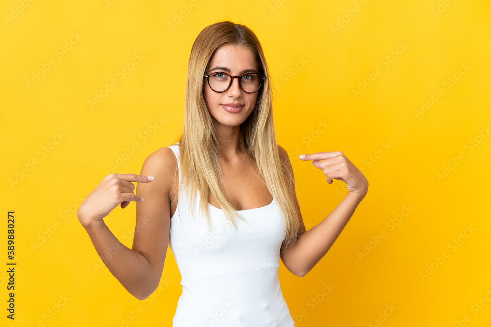 Young blonde woman isolated on yellow background pointing to oneself Young blonde woman isolated on yellow background pointing to oneself