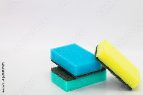 Colored washcloths for the kitchen. Cleaning of the apartment. Cleaning sponges on a white background. Sponges for washing dishes, household goods.