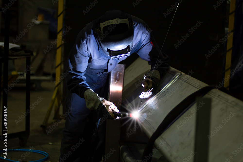 Metal workers use manual labor, Skilled welder, Factory workers making OT. Welder is welding the steel in the factory. Metal workers use manual labor, Skilled welder, Factory workers making OT. Welder is welding the steel in the factory.