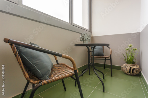 dinner tea table with chairs on the loggia in light interior photo