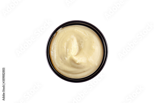 Sauce garlic in a plastic disposable dish on a white background, top view. Isolated