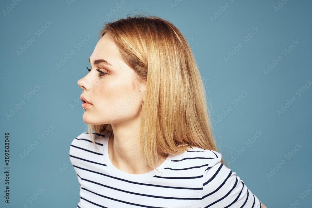 woman wearing striped t-shirt cropped view blue isolated background displeased facial expression woman wearing striped t-shirt cropped view blue isolated background displeased facial expression