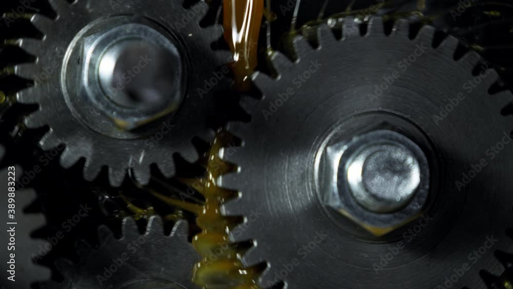 Super slow motion of rotating engine steel wheels with oil splashes. Filmed on high speed cinema camera, 1000 fps. Super slow motion of rotating engine steel wheels with oil splashes. Filmed on high speed cinema camera, 1000 fps.