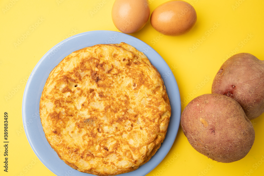 omelette with potatoes on yellow background