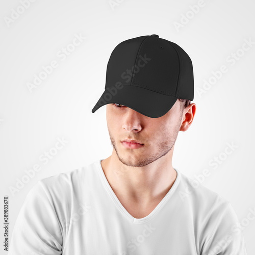 Canvas Print Mockup of a black baseball cap on a guy's head, looking from under a visor, front view, empty panama for design presentation