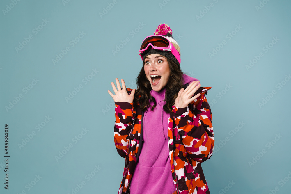 Happy young woman wearing snowboarding gear