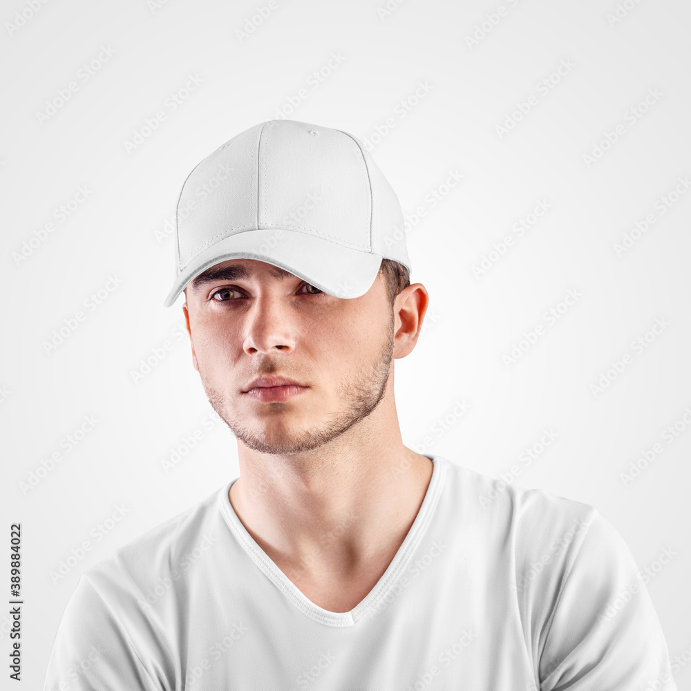Mockup of a white sports panama on the head of a guy in a T-shirt, isolated on background.