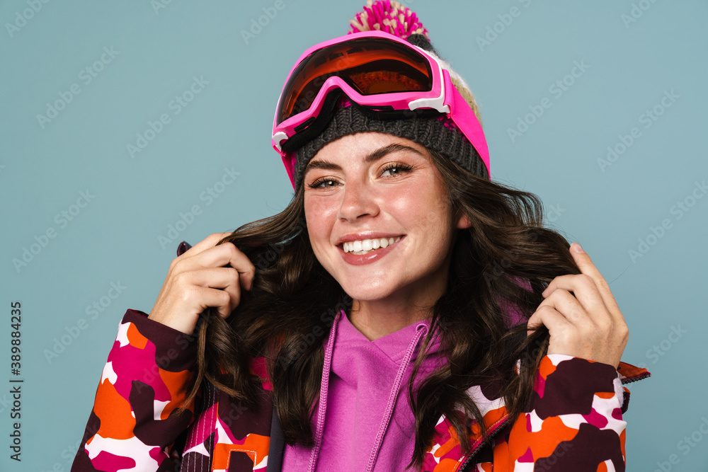 Happy young woman wearing snowboarding gear Happy young woman wearing snowboarding gear