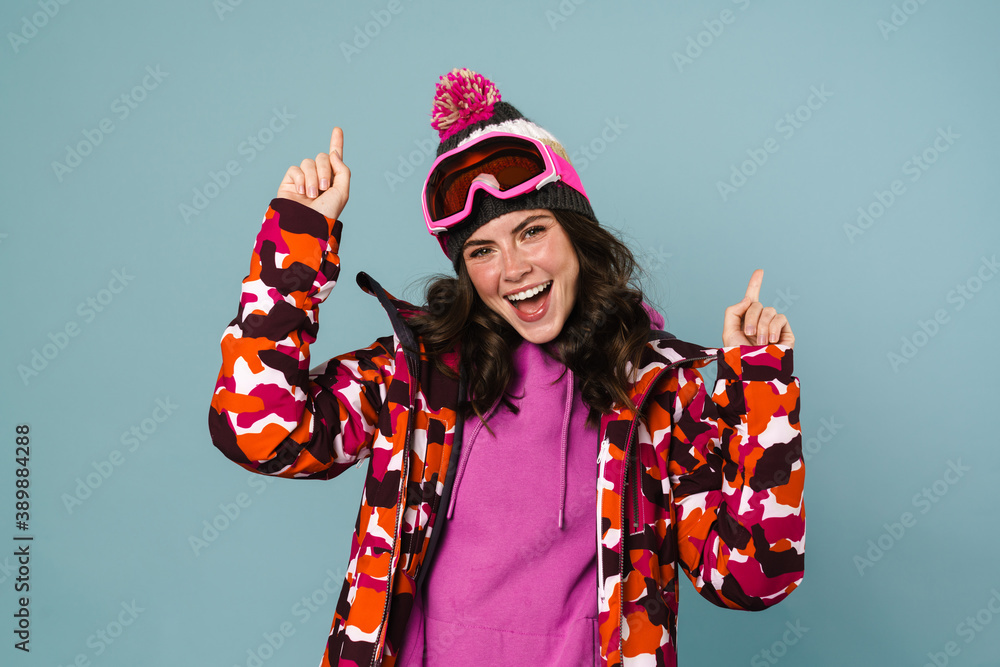 Excited young woman wearing snowboard jacket Excited young woman wearing snowboard jacket